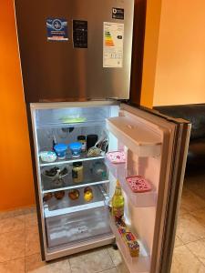 a refrigerator with its door open in a room at Tu departamento en Formosa in Formosa