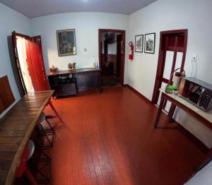 a living room with a red tile floor at Nuh Hostel - Quartos coletivos in Ouro Preto