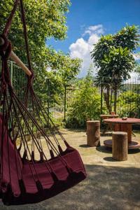 a hammock in a park with a picnic table at Nuh Hostel - Quartos coletivos in Ouro Preto