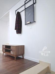 a room with a dresser and a sign on the wall at Refúgio da Vila in Vila de Rei +19 photos