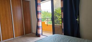 a bedroom with a window with a view of a balcony at Feri Lodge in Tohautu