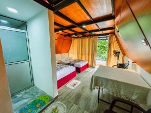a small room with a bed and a shower at Sunshine Cabana and Resort in Haldummulla