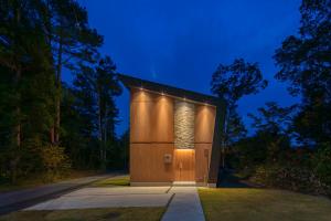 a building with a door in the middle of a road at Chalet Infinity in Hakuba