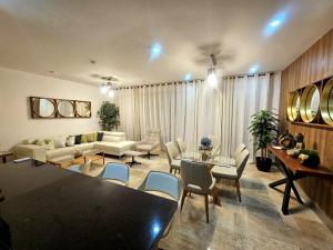 a living room with a couch and a table and chairs at Cancún Arbolada Huayacan in Cancún
