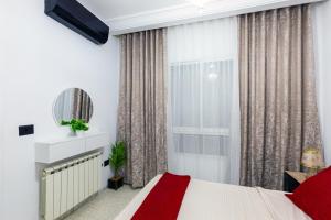 a bedroom with a bed and a window at VIP Home in El Aouina Station