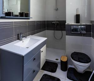a bathroom with a sink and a toilet at VIP Home in El Aouina Station +7 photos