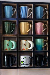 a shelf filled with cups and mugs at VIP Home in El Aouina Station