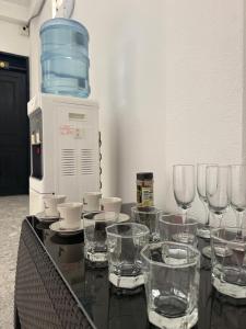 a table with wine glasses on top of it at Hotel SR, Villa Garzón in Villagarzón