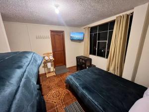 a bedroom with a bed and a window at Granja Doña Carmelita in Ibarra +39 photos