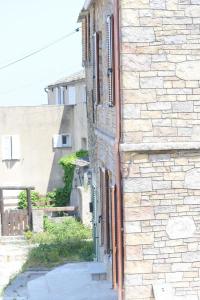 an entrance to a brick building with open windows at Villa San Martino in San-Martino-di-Lota +21 photos