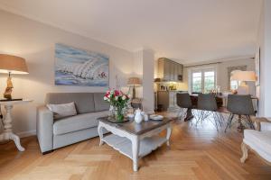 a living room with a couch and a table at Deichgraf 4 in Kampen +33 photos