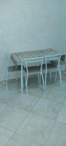 a table and a chair with a table and a bench at rooms maissa 1 in Cabo Bojador