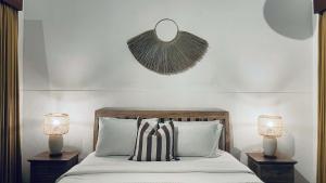 a bedroom with a bed with two nightstands and two lamps at Villa Searenity Seminyak in Seminyak +43 photos