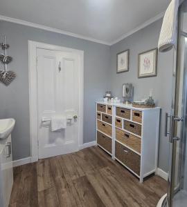 a bathroom with a white dresser and a sink at The Coal House in Townhill +40 photos
