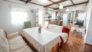 a living room with a table and a couch at Casa de la Abuela - Encanto rural para grupos in Campofrío
