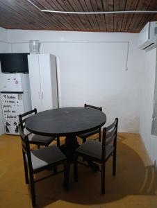 a black table and chairs in a room at Tu alojamiento in Tacuarembó