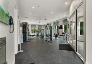 a gym with treadmills and ellipticals in a building at Stunning Townhouses 5 Minutes away Disney! in Kissimmee