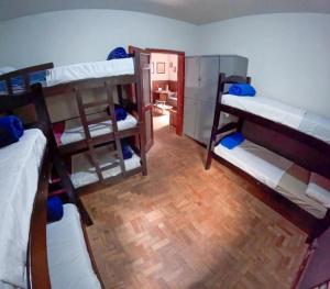 a room with three bunk beds in a room at Nuh Hostel - Quartos coletivos in Ouro Preto +7 photos