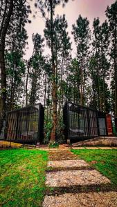 two gates in a park with trees in the background at Pineforrest in Sukapura +10 photos