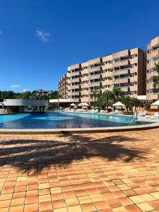 a large swimming pool with buildings in the background at Gran Lençóis Flat Residence Mandacaru 411 in Barreirinhas