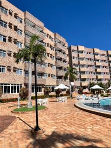 a large apartment building with a courtyard with a swimming pool at Gran Lençóis Flat Residence Mandacaru 411 in Barreirinhas