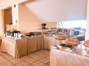 a banquet hall with tables with white table cloth at Planet Dunas in Aquiraz