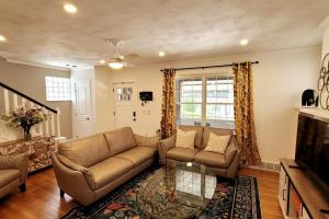a living room with a couch and a table at The Brookline Retreat in Pittsburgh