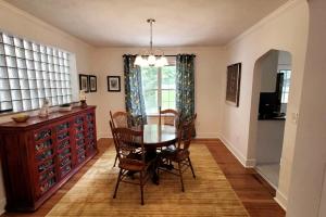 a dining room with a table and chairs and a window at The Brookline Retreat in Pittsburgh