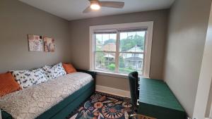 a living room with a couch and a window at The Brookline Retreat in Pittsburgh