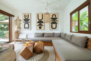 a living room with a couch and a table at Villa Jacelyne - Tropical 2BR Villa with Private Pool in Canggu in Dalung