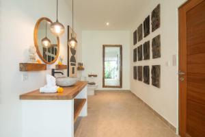 a bathroom with a sink and a mirror at Villa Jacelyne - Tropical 2BR Villa with Private Pool in Canggu in Dalung