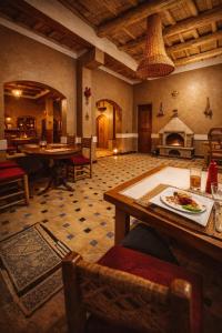 a living room with a table with a plate of food at Riad pizzeria Marhaba in Akhendachou nʼAït Ouffi