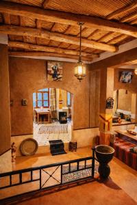 a large living room with a wooden ceiling at Riad pizzeria Marhaba in Akhendachou nʼAït Ouffi
