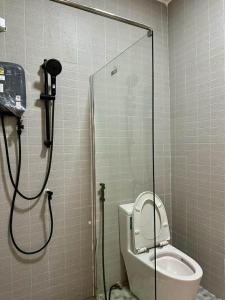a bathroom with a shower and a toilet in a stall at Apples Pattaya Townhouse in Pattaya South