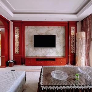 a living room with a television on a wall at 青云小栈 in Shaoxing