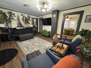 a living room with a couch and a table at The Renovated Farmhouse at Seneca Rocks in Seneca Rocks