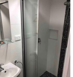 a bathroom with a shower and a sink at Dees Rear Studio Room in Hazelbrook