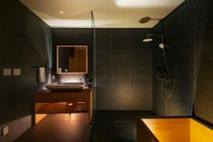 a bathroom with a shower and a sink at Kairos by the Mountain in Hakuba +29 photos
