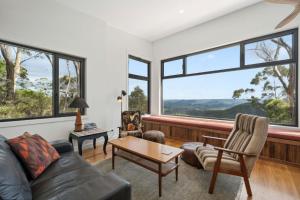 a living room with a couch and a table at Sunset Retreat in Mount Victoria