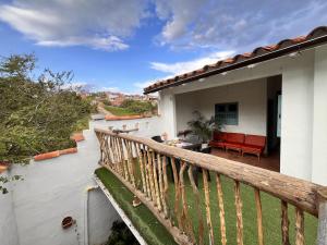 a balcony of a house with a wooden railing at Casa Quintanilla Barichara in Barichara