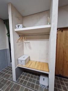 a room with a shelf with two boxes on it at Origami in Palmas