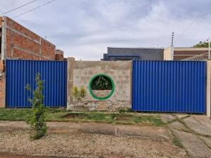 a blue wall with a green circle on top of it at Origami in Palmas