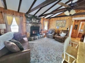 a living room with a couch and a fireplace at WILDFLOWER CABINS LIMIT 6 villa in Naples