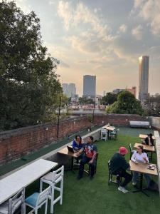 a group of people sitting at tables on a roof at Nomaddicts in Mexico City