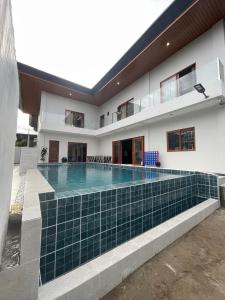 a swimming pool in the backyard of a house at Norwil Manor Tagaytay in Tagaytay