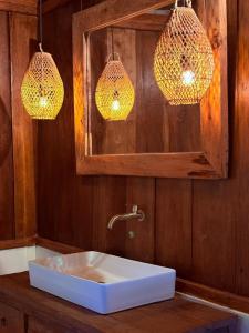a bathroom with a sink with two lights and a mirror at The Angkayo in Angkayo +91 photos