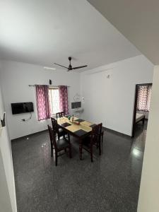 a dining room with a table and chairs at Anchery homes in Trichūr