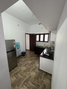 a kitchen with a counter top and a refrigerator at Anchery homes in Trichūr