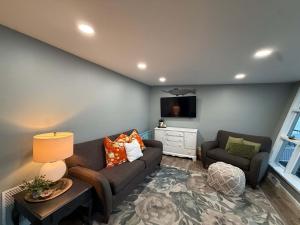 a living room with a couch and a chair at Lucky Duck Lakefront Fire Pit in Gravois Mills