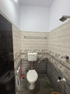 a bathroom with a toilet and a shower at Anchery homes in Trichūr